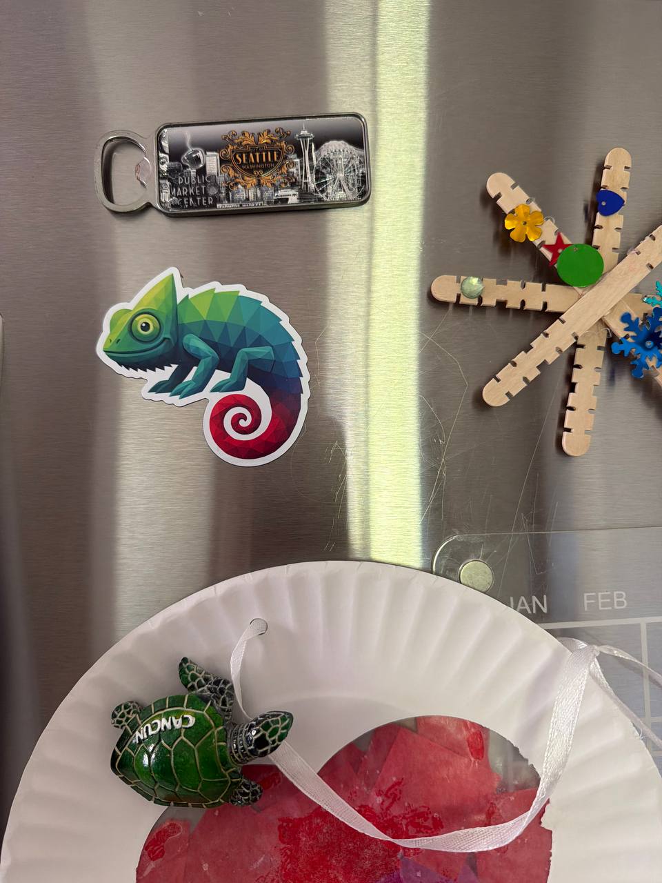 Chameleon sticker on a fridge next to Pike Place Market magnet